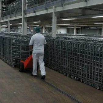 TET Pedestrian Pusher moving dairy roll cages - Arla Foods - pushing loads